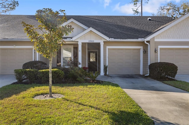 view of property with driveway, a front lawn, board and batten siding, and roof with shingles