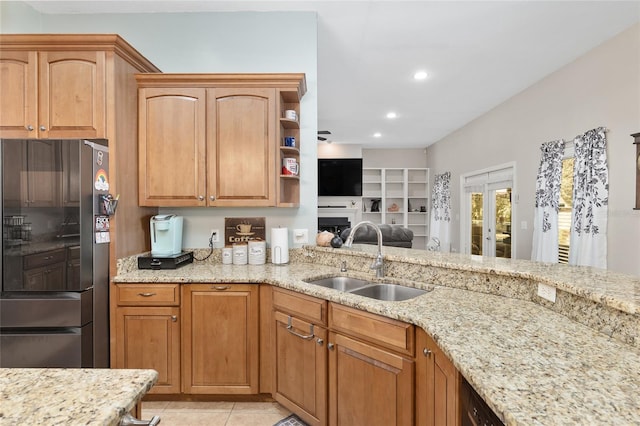 kitchen with open shelves, light stone counters, smart refrigerator, and a sink