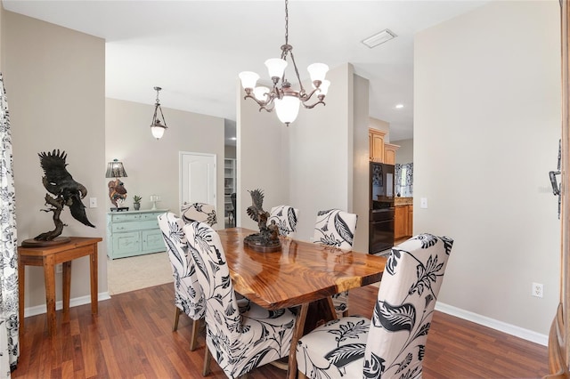 dining area with dark wood-style floors, visible vents, baseboards, and an inviting chandelier