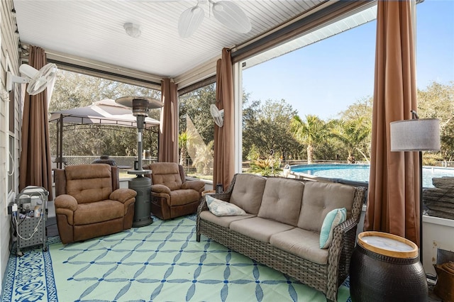 sunroom / solarium with a ceiling fan