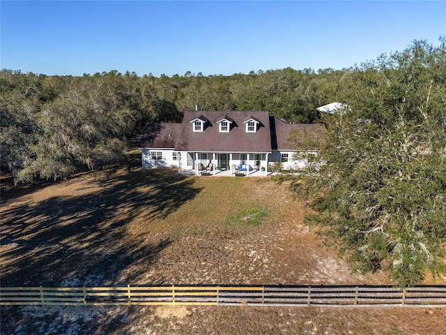 birds eye view of property featuring a rural view and a view of trees