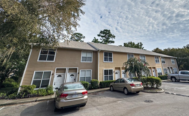 multi unit property featuring uncovered parking and stucco siding