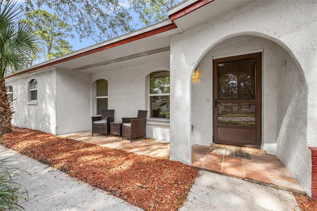 property entrance with stucco siding