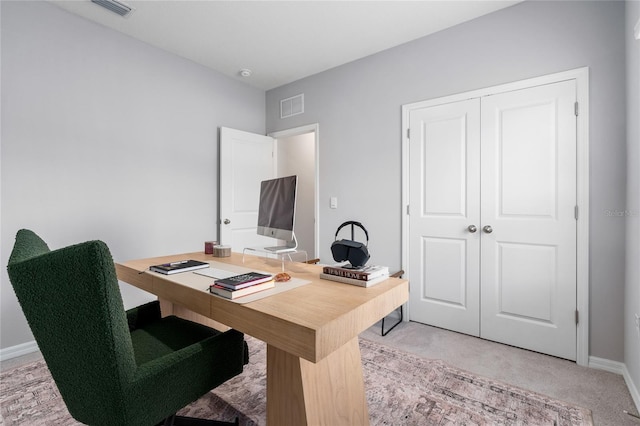 carpeted office space featuring baseboards and visible vents