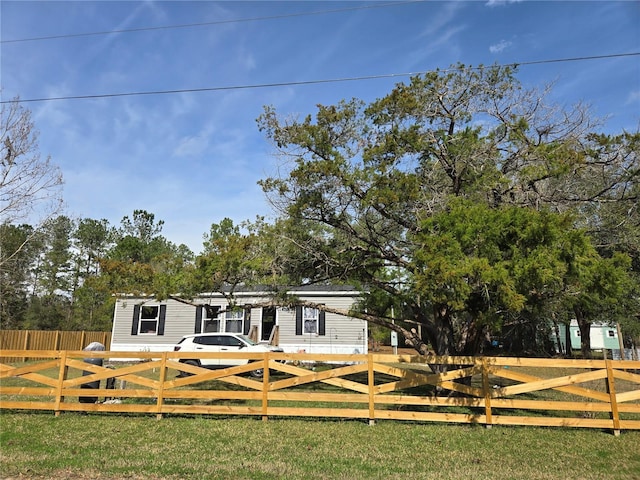 rear view of property with a fenced front yard