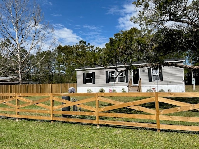 exterior space featuring entry steps, a yard, and fence