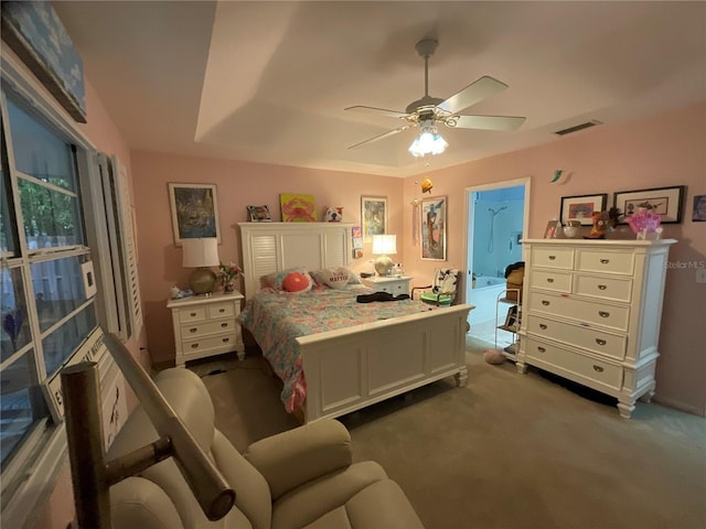 carpeted bedroom featuring a ceiling fan and visible vents