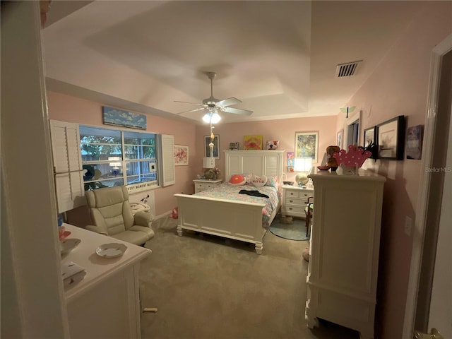 bedroom with a ceiling fan, visible vents, and light colored carpet