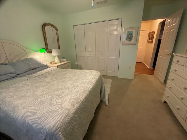 bedroom with a closet and light colored carpet