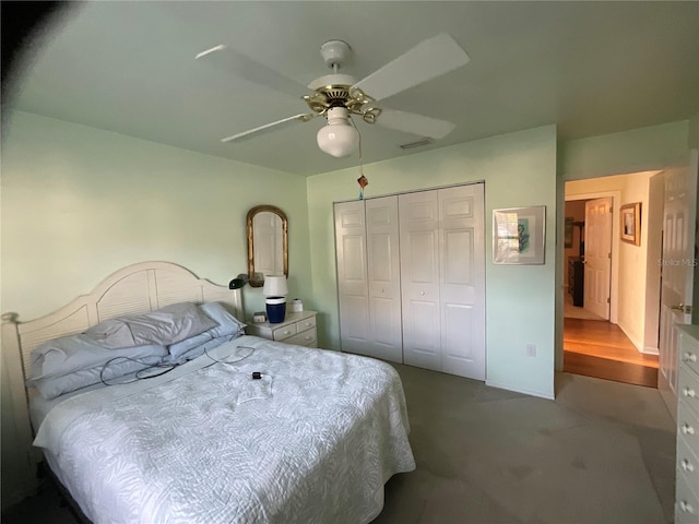 carpeted bedroom with ceiling fan, a closet, and visible vents