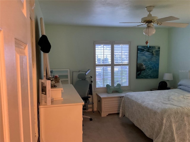 bedroom featuring a ceiling fan and light colored carpet