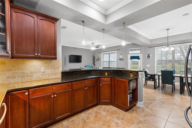 kitchen with dark stone countertops, pendant lighting, tasteful backsplash, and ornamental molding