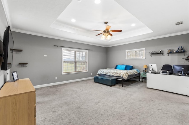 bedroom featuring multiple windows, carpet, a tray ceiling, and ornamental molding