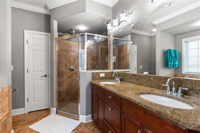 full bathroom with a stall shower, crown molding, and a sink