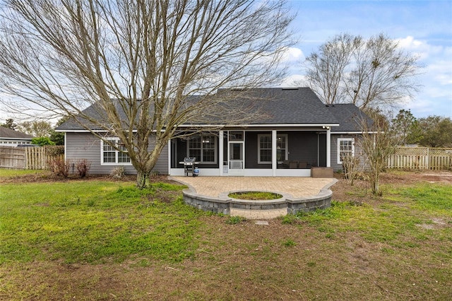 rear view of property featuring a yard, fence, roof with shingles, and a sunroom