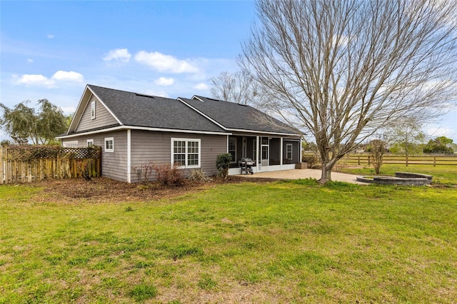 back of house with a patio area, fence, a yard, and a sunroom