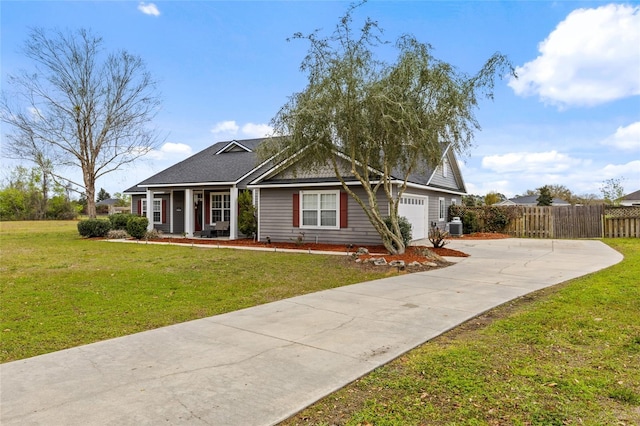 view of front of house with driveway, a front yard, an attached garage, and fence