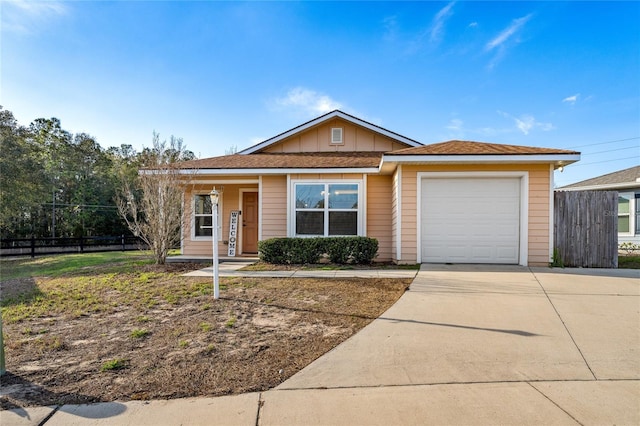 single story home with an attached garage, fence, board and batten siding, and concrete driveway