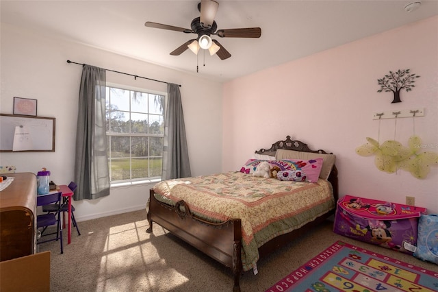 carpeted bedroom featuring baseboards and a ceiling fan