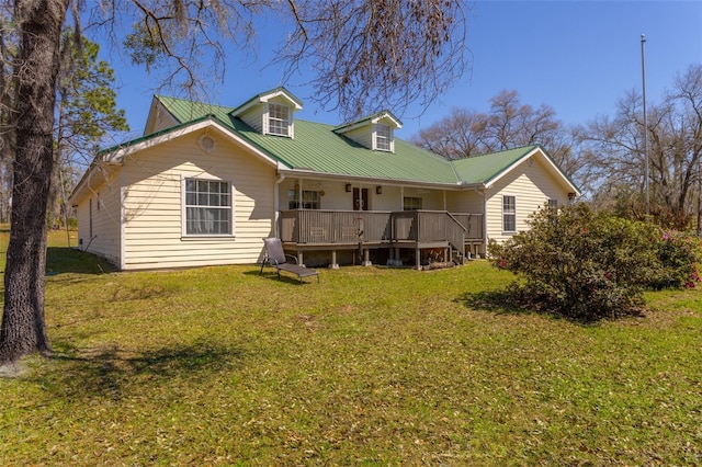 back of property with a yard and metal roof