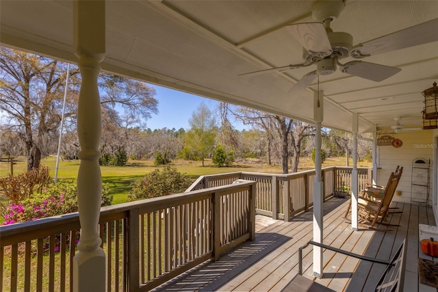 wooden terrace featuring ceiling fan