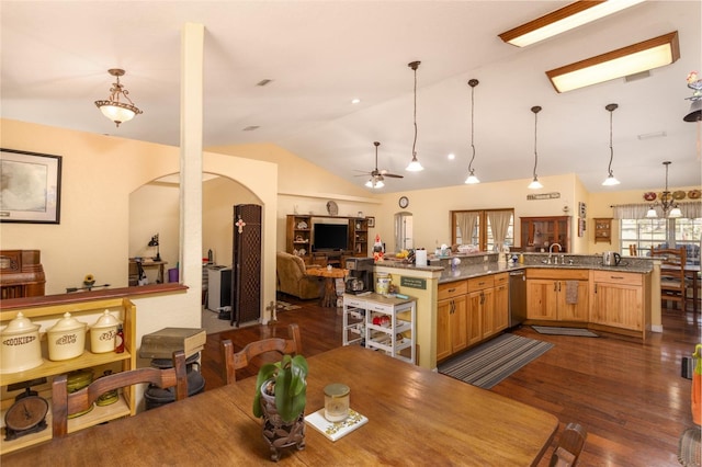 dining space featuring arched walkways, dark wood-type flooring, a ceiling fan, and vaulted ceiling