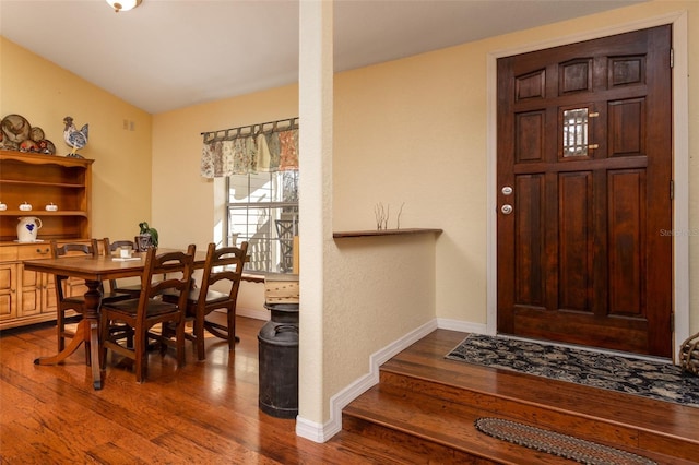 dining room with baseboards and dark wood finished floors