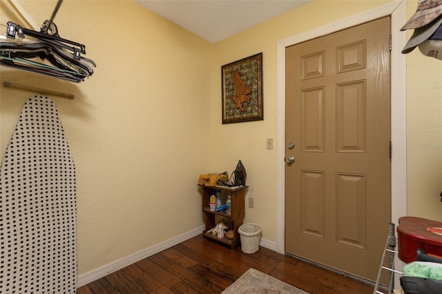 entrance foyer with dark wood finished floors and baseboards