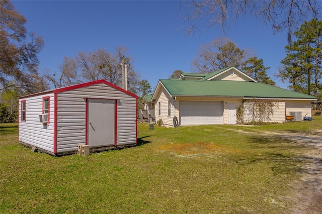 view of shed featuring an attached garage, driveway, and central AC