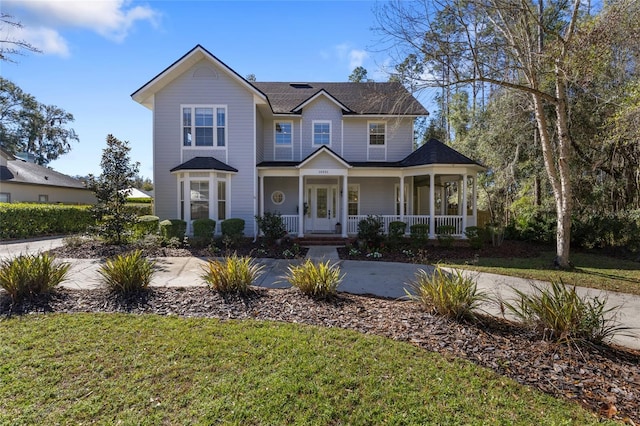 view of front of house with a front yard and a porch