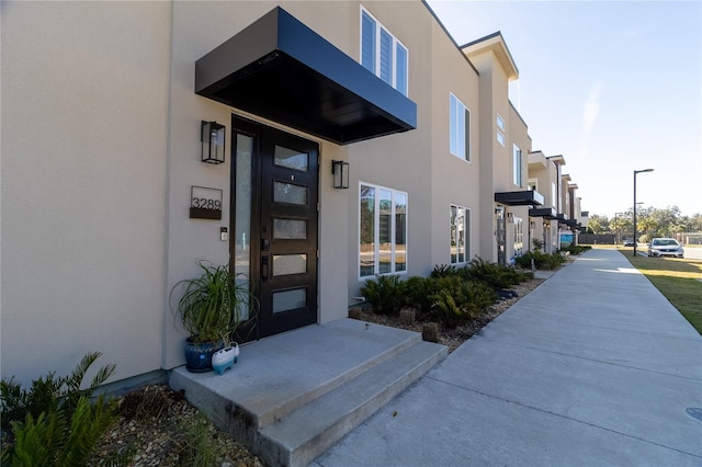 property entrance featuring stucco siding