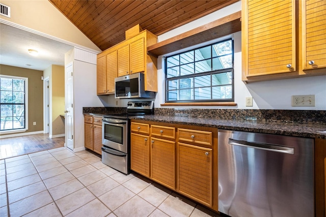 kitchen with light tile patterned floors, visible vents, wooden ceiling, vaulted ceiling, and stainless steel appliances