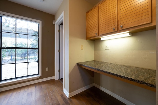 kitchen with built in desk, plenty of natural light, and baseboards