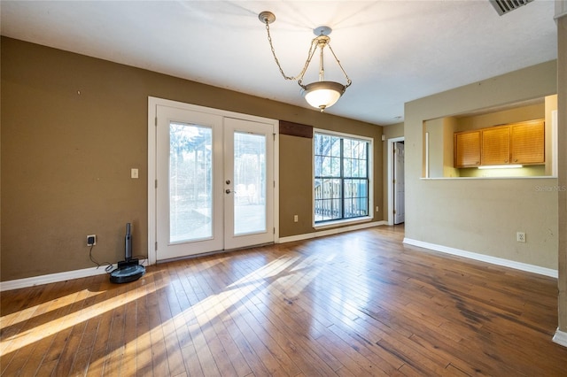 doorway to outside with wood-type flooring, baseboards, visible vents, and french doors