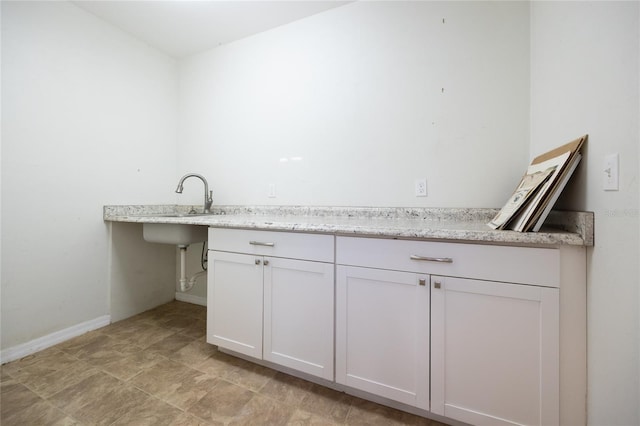 laundry area with baseboards