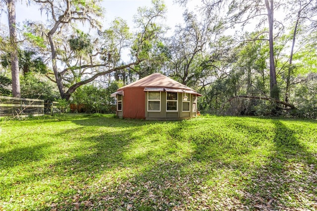 view of yard featuring fence and an outdoor structure