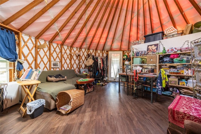 living area featuring lofted ceiling and wood finished floors