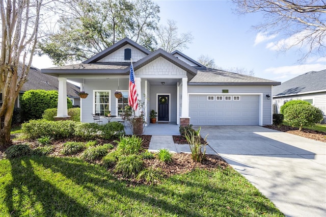 craftsman-style house with covered porch, driveway, and an attached garage