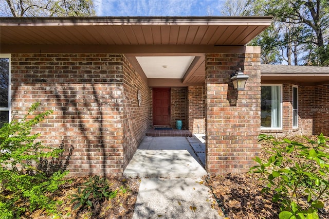 entrance to property featuring brick siding