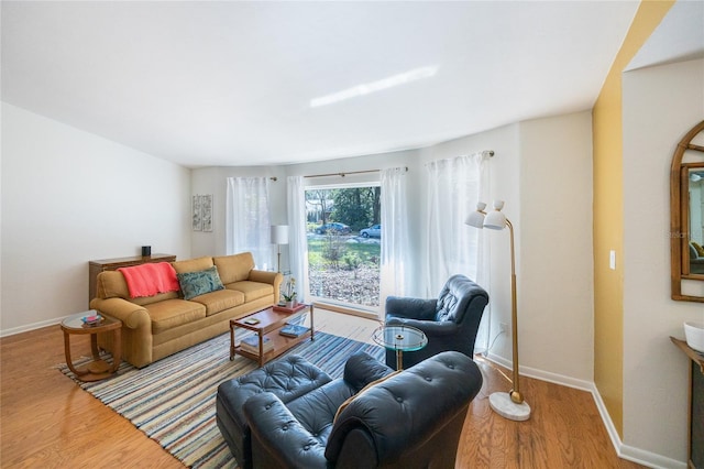 living room with wood finished floors and baseboards