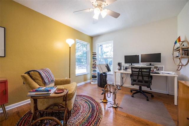 office featuring ceiling fan, baseboards, and wood finished floors