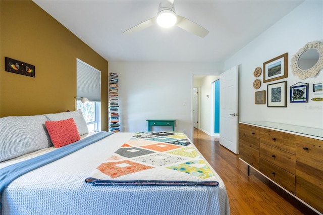 bedroom featuring a ceiling fan, wood finished floors, and baseboards