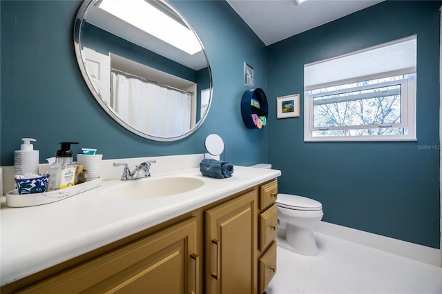 bathroom featuring vanity, toilet, and tile patterned flooring