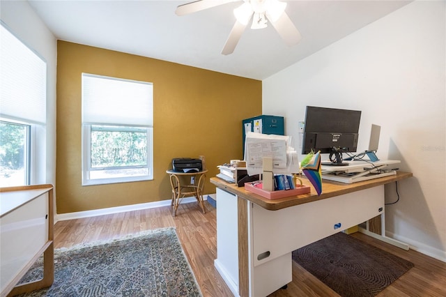 home office featuring a ceiling fan, wood finished floors, and baseboards