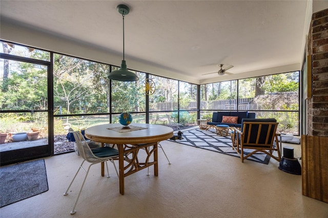 sunroom featuring a ceiling fan and a wealth of natural light