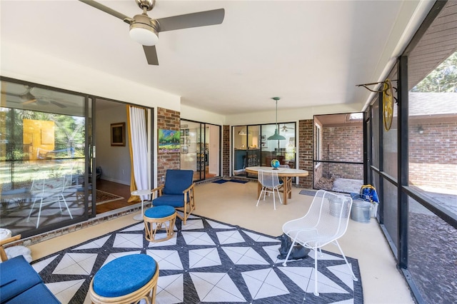 sunroom with a wealth of natural light and ceiling fan