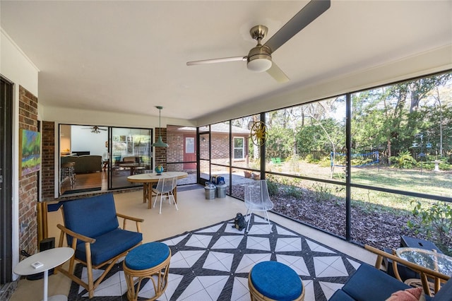 sunroom / solarium featuring a ceiling fan