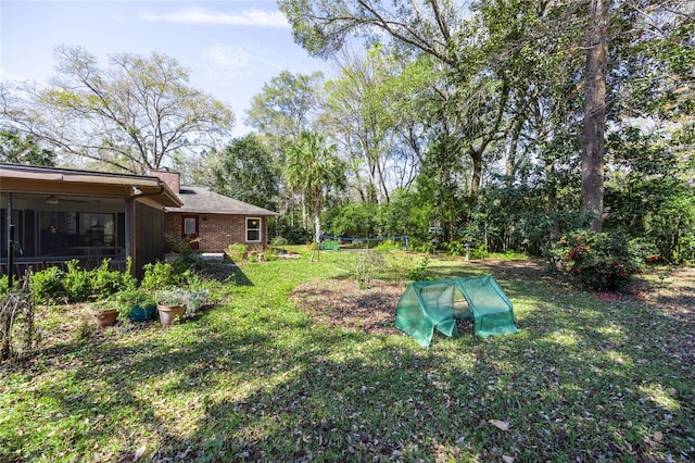 view of yard featuring a sunroom