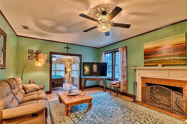 living room featuring ornamental molding, a wealth of natural light, and wood finished floors