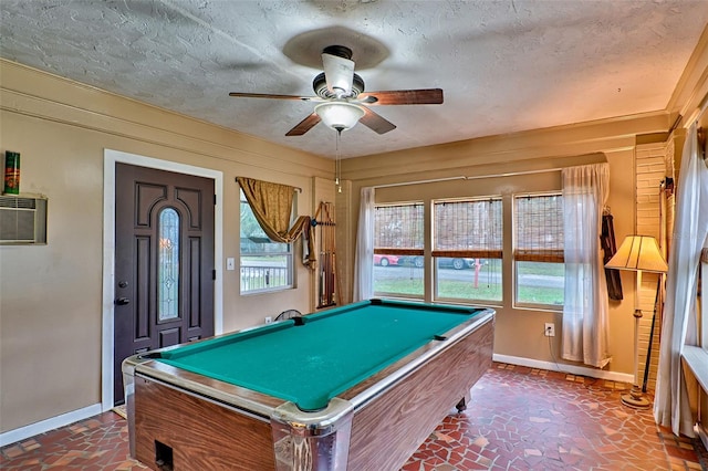 playroom with a textured ceiling, baseboards, and a healthy amount of sunlight